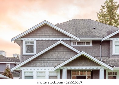 A Perfect Neighborhood. Houses In Suburb At Fall In The North America. Top Of A Luxury House With Nice Window Over Dramatic Pink Clouds In The Sky.