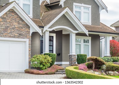 A perfect neighborhood. Houses in suburb at Spring in the north America. Fragment of a luxury house with entrance door and nice window.