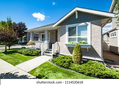 Perfect neighbourhood. Entrance of residential house with concrete pathway in front of the house. Family house on bright sunny day - Shutterstock ID 1114520618
