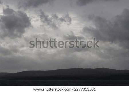 perfect photo of the dark clouds in sky and vast sea on cold, rainy day. pessimistic, lonely, emotional, cold, gloomy climate. Bosphorus bridge in distance, yellow sunset and dark cumulus clouds.
