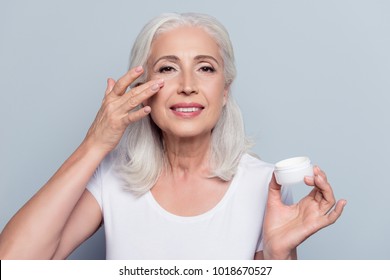 Perfect, Pretty, Woman Applying Eye Cream, Holding Jar Of Cosmetic Product Looking At Camera Over Gray Background