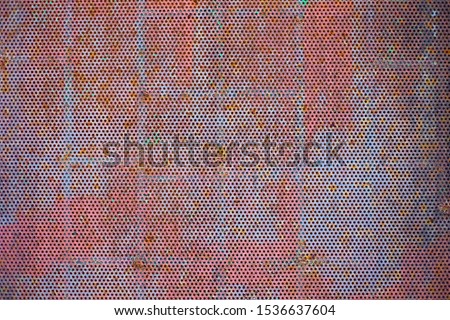 Perfect red and gray rusting perforated metal material for graphic background or backdrop.