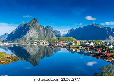 Perfect reflection of the Reine village on the water of the fjord in the Lofoten Islands, Norway - Shutterstock ID 2320352977