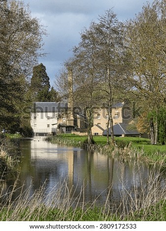 A perfect reflection of sky and building. Old style Watermill
