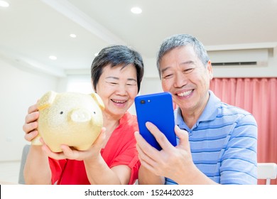 Perfect Retire plan concept - eldely couple hold piggy bank and smartphone happily at home - Powered by Shutterstock