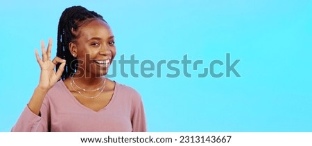 Perfect, sign and woman with okay hand gesture smile and happy with mockup space isolated in a studio blue background. Portrait, satisfaction and African American woman with support and winning emoji