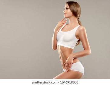  Perfect slim toned young body of the girl . An example of sports , fitness or plastic surgery and aesthetic cosmetology.