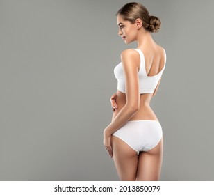 Perfect slim toned young body of the girl . An example of sports , fitness or plastic surgery and aesthetic cosmetology. - Shutterstock ID 2013850079