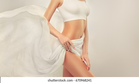 Perfect slim toned young body of the girl . An example of sports , fitness or plastic surgery and aesthetic cosmetology. Healthy Breast .