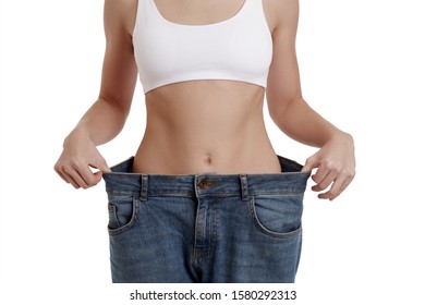 Perfect, Slim, Young Body Of A Girl In White Underwear. Weight Loss And Healthy Eating. A Woman In Jeans Of Large Size. The Problem Of Obesity. Plastic Surgery.