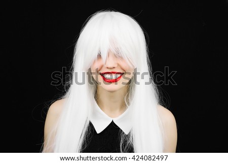 Perfect smile crazy woman in white wig with red lips. Fun girl with white beautiful teeth, school teacher style. Young cheerful girl having fun. Bright makeup and hairstyle black isolated background.