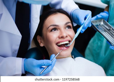 Perfect Smile! Part Of Dentist Examining His Beautiful Patient In Dentist’s Office
