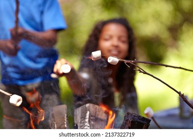 The perfect snack to enjoy with friends. Kids roasting marshmallows on an open fire. - Powered by Shutterstock