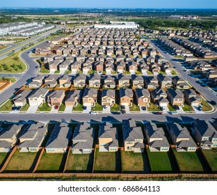 Perfect Standard Suburban Neighborhood Aerial Drone View above the entire development in North Austin right next to Round Rock , TX a perfect repeating pattern of Homes rows and rows of houses