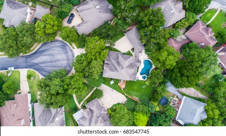 Perfect Straight Down View Above Nice Luxury Multi Story Home In Austin Texas Suburb With Nice Backyard Swimming Pool Green Tall Trees And Cul De Sac End Of Street