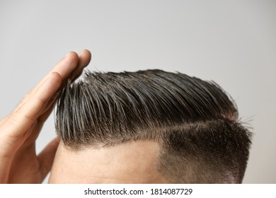 Perfect Styling Of Hair After Barbershop On The Grey Background. Hair Loss Treatment Concept. Mens Cosmetic Products Concept.