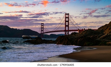 Perfect Sunset Over San Francisco Golden Gate Bridge With Pink And Purple Colors With Empty Sandy Beach With Coastal Mountains Of The Bay Area 