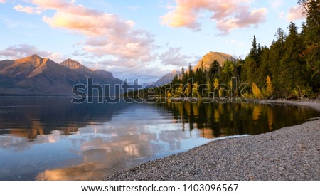 A perfect sunset view from the rocky shores of Lake McDonald in Glacier National Park, Montana.