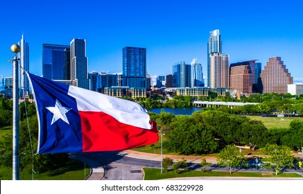 Perfect Texas Flag Waving In Front Of The Perfect Austin Texas USA Skyline Representing The Lone Star State With Drone View Of Our Iconic Capital City 