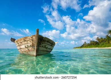 Perfect tropical island paradise beach and old boat