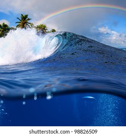 Perfect Tropical Ocean View Splitted By Waterline To Two Part. Shorebreak  Breaking Surfing Wave. Palms And Clouds In Daylight With Colorful Rainbow.