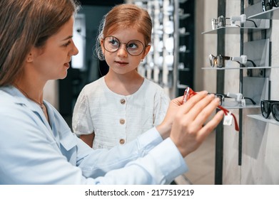 Perfect Vision. Woman And Girl Is In The Glasses Store Choosing Eyewear Together.