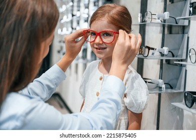 Perfect Vision. Woman And Girl Is In The Glasses Store Choosing Eyewear Together.