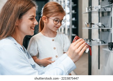 Perfect Vision. Woman And Girl Is In The Glasses Store Choosing Eyewear Together.