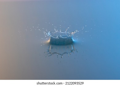 Perfect water drop crown splash on blue water