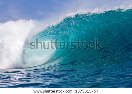 perfect wave breaking in Indonesia on a shallow reef