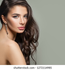 Perfect woman with long wavy hairstyle, makeup and diamond jewelry earrings - Shutterstock ID 1272114985