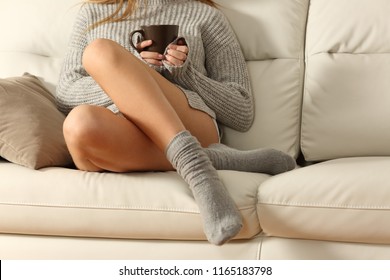 Perfect Woman Waxed Legs In Winter Sitting On A Couch In The Living Room At Home