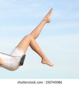 Perfect Woman Waxing Hair Removal Legs Swinging With The Blue Sky In The Background