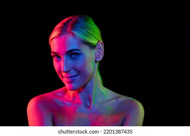 Perfection  Beauty portrait young adorable woman and well  kept skin isolated over dark background in pink neon light  Concept art  fashion  style  inspiration  emotions  Copy space for ad