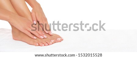 Perfectly done manicure and pedicure on female feet isolated on white background.