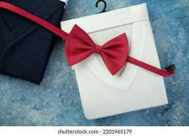 Perfectly Folded V Neck T-shirts And Red Bow Tie. Top View