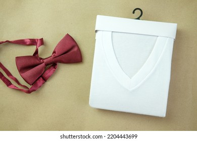 Perfectly Folded V Neck T-shirts And Red Bow Tie. Top View