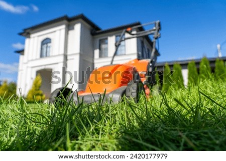 A perfectly manicured lawn is guarded by a resplendent house, with a trusty lawn mower standing as a symbol of unwavering care and diligence, ready to tend to its surroundings.