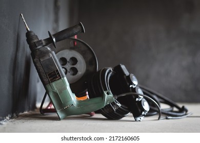 Perforator Drill On The Dusty Floor Of Construction Site Close Up.