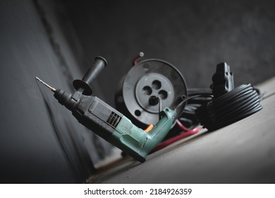 Perforator Drill On The Dusty Floor Of Construction Site Close Up.