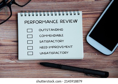 Performance Appraisal Checklist On Notepad With With Office Setting Background. Performance Review Concept