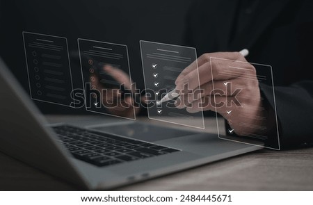 Performance checklist concept : businessman using stylus pen with laptop for questionnaire, evaluation, assessment online or survey exam and filling out for digital survey and checklist.	