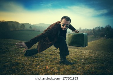 performance, a man with a green suitcase