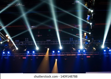 Performance moving lighting on construction light beam ray downward in yellow blue color, on Concert and Fashion Show stage ramp. LED par new technology to save power more color and high density Light