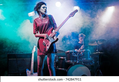 Performance of the rock band. The guitarist plays solo. The bass player plays solo. Drummer. Bass drum. Close-up. - Powered by Shutterstock