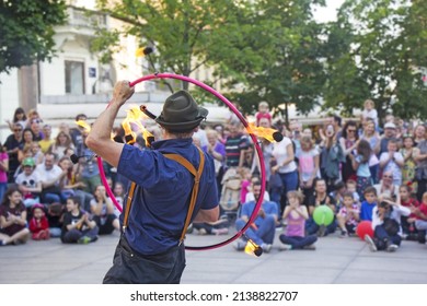 Performer at Cest is d’best street festival with a fire wheel making circle of fire