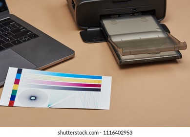 Performing Color Printer Test Paper Strip On Home Desk Background