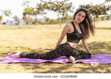 Performing Yoga Exercises A Young Woman With Long Hair, Natural Beauty With Daylight, Healthy Fitness Lifestyle With Nature