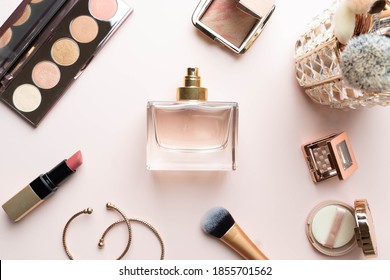 Perfume Bottle With Makeup Cosmetics On Pink Dressing Table. Scent Fragrance Cosmetic Beauty Product. Beauty Blogger Concept. Flat Lay.