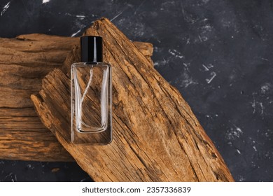 perfume bottle mockup, perfume bottle on wood, with black background.